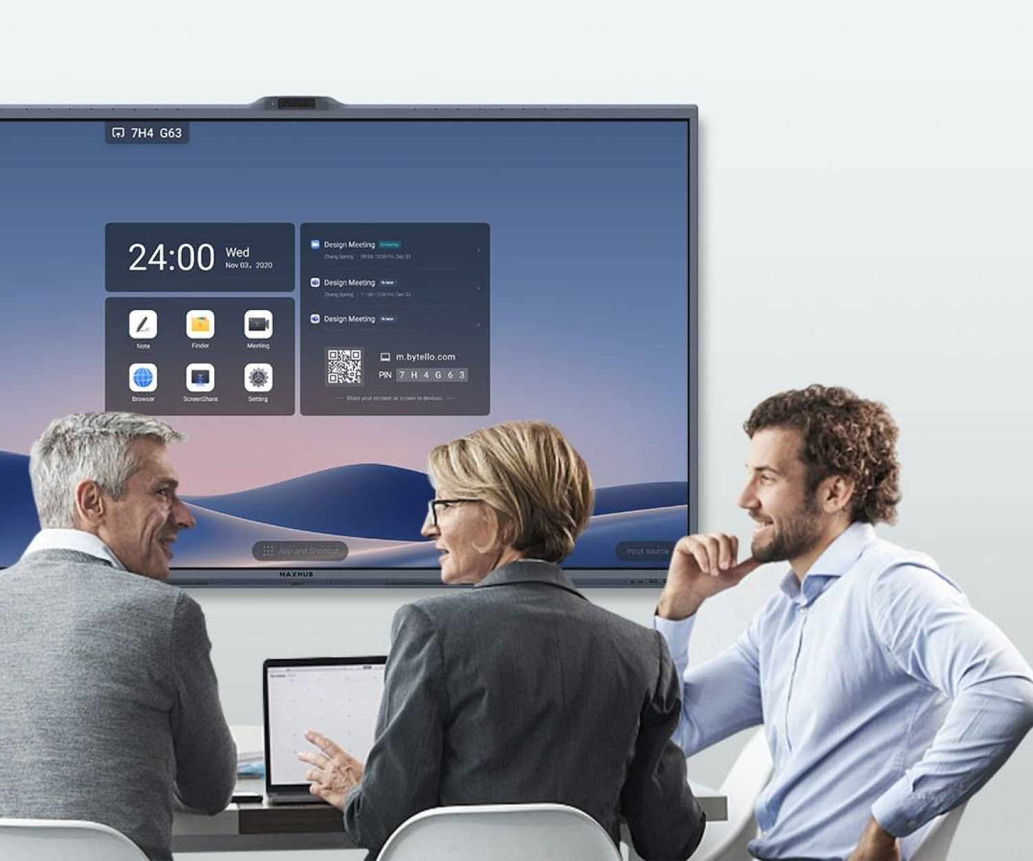 Team meeting around a conference table with an all-in-one display