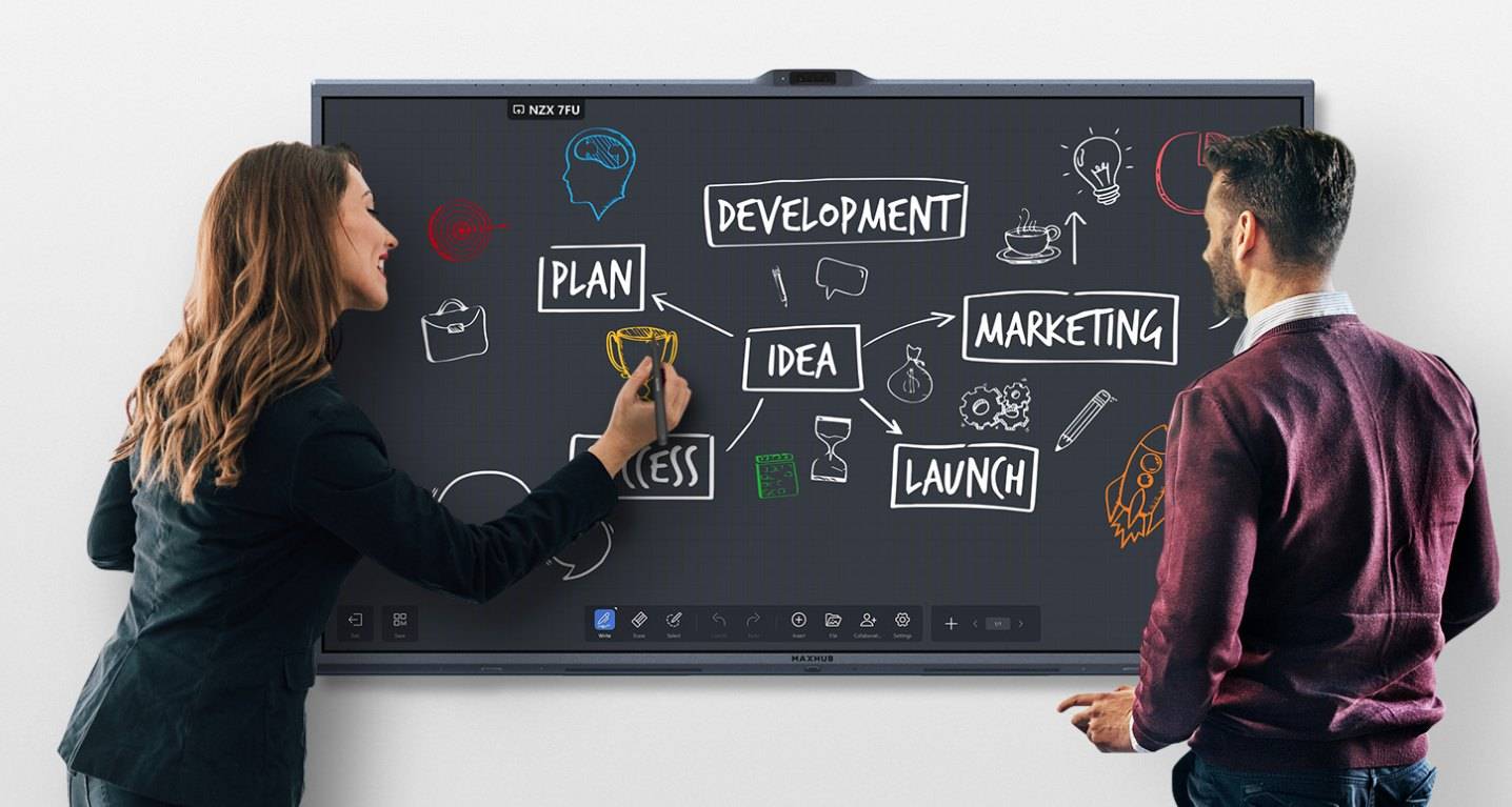 Two colleagues brainstorming on an interactive conference room display